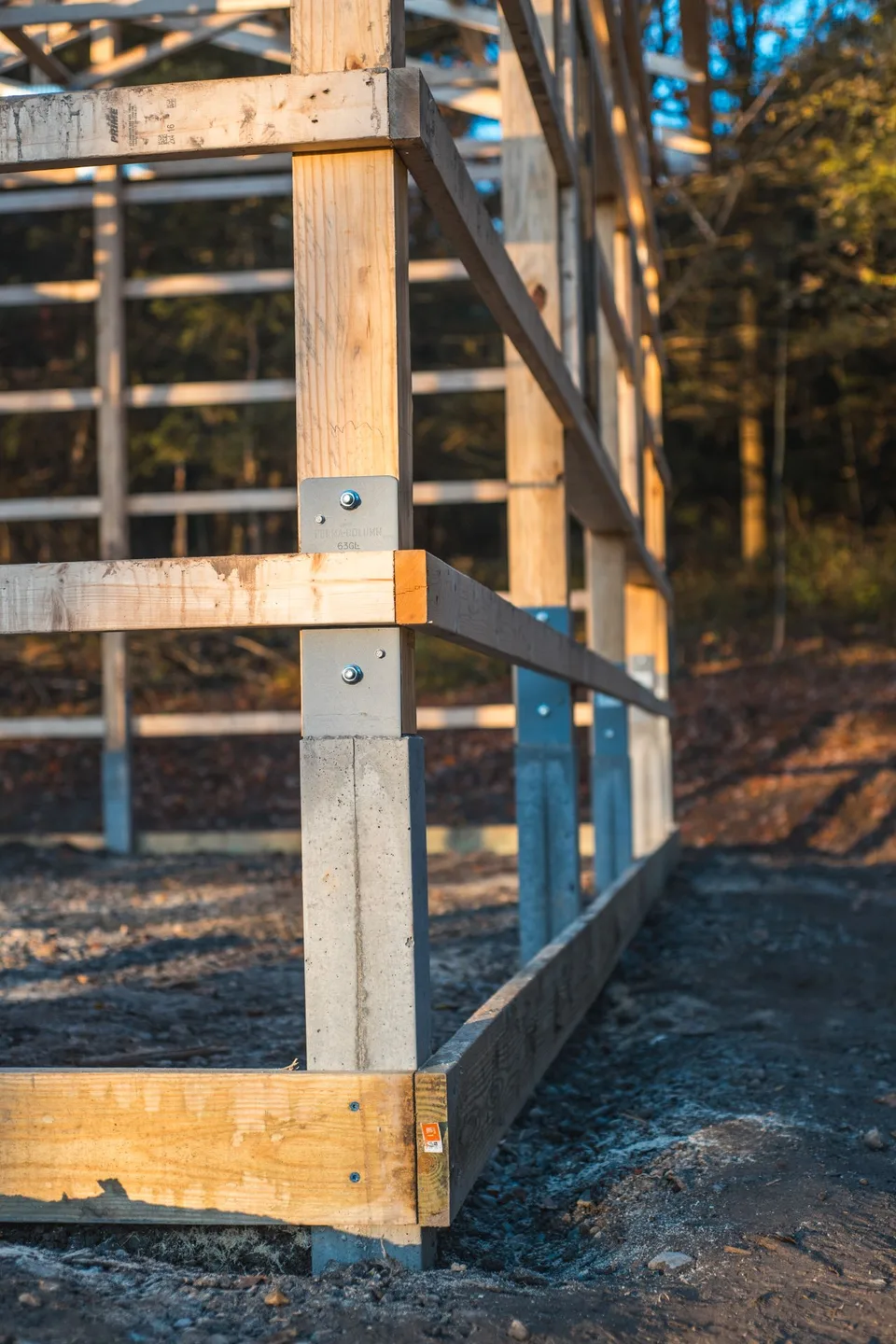 Pole barn timber framing anchored to concrete columns
